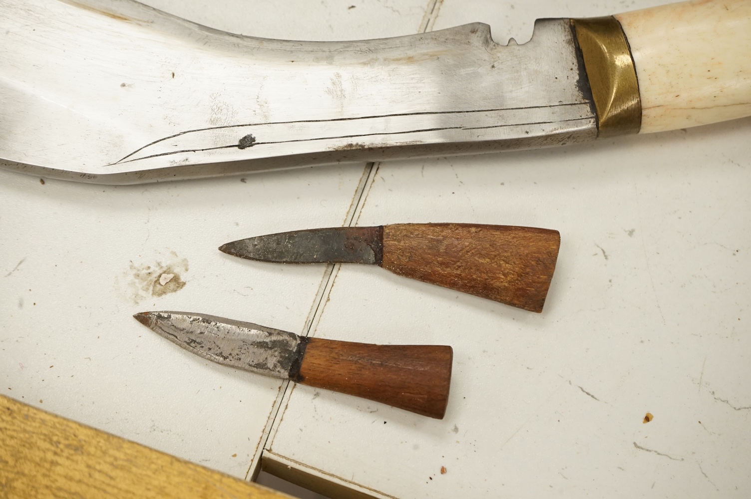 A bone handled Kukri knife, in mounted sheath